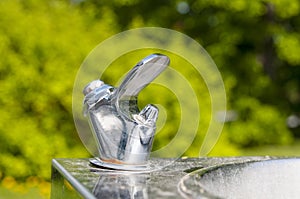 Drinking tap close up in public park in the city at summer