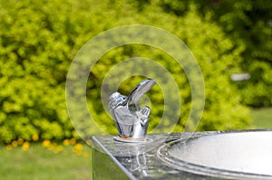 Drinking tap in public park in the city at summer