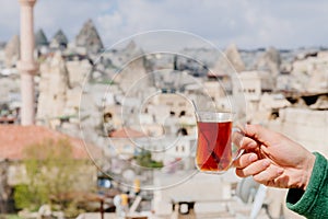 Drinking turkish tea in front of old city Goreme