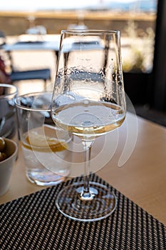 Drinking of txakoli or chacolÃ­ slightly sparkling very dry white wine produced in Spanish Basque Country, served in restaurant in