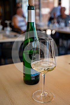 Drinking of txakoli or chacolÃ­ slightly sparkling very dry white wine produced in Spanish Basque Country, served in restaurant in