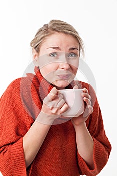 Drinking warm beverages for happy blond girl holding a hot tea