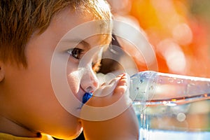 Drinking water from bottle. Thirsty child little boy baby drink water. Portrait of a boy with a bottle of mineral water