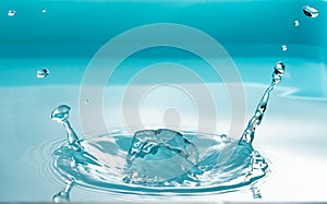 Drinking of water drop splash isolated on blue background