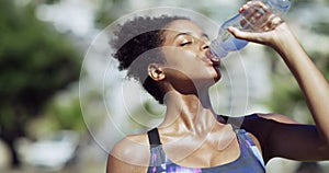 Drinking water, fitness and woman outdoor after training, sport run and workout. Exercise, runner and thirsty African