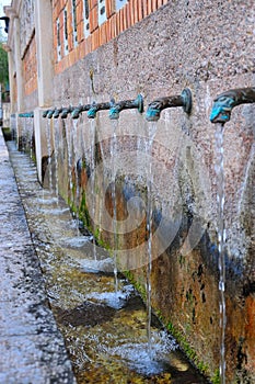 water fountain with bronze pipes in Segorbe, Spain photo