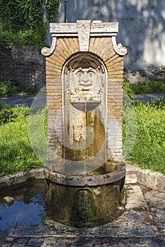 A Drinking water fountain Fontanella di Nerone in park Parco del Colle Oppio e delle terme di Traiano in Rome, Italy photo