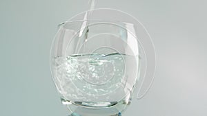 Drinking water in a glass on a white background. Pour water into a transparent glass close-up.