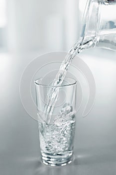 Drinking Water. Pour Water From Pitcher Into A Glass. Health, Di
