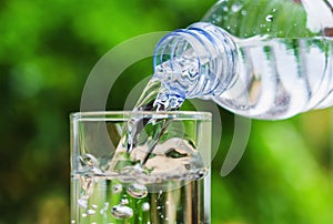 Drinking water poured into the glass and sunlight