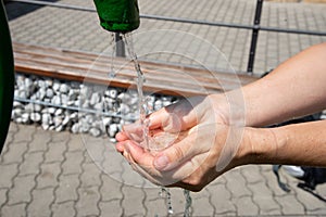 Drinking water puring into open palm