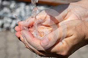 Drinking water puring into open palm