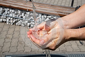 Drinking water puring into open palm