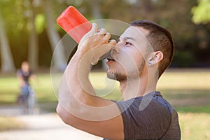 Drinking water runner young man drink jogger sports training fitness workout