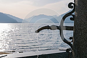 Drinking water tap on the Lake Ceresio at Bissone near Lugano. Switzerland