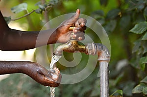 Drinking Water from a Tap - Water Scarsity Symbol