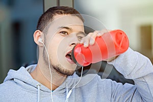 Drinking water young man runner running jogging sports training fitness