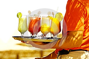 Drinks on the beach. Waiter serving drinks and cocktails on beach