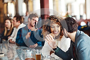 Drinks are always better with the best company. a couple enjoying a drink at a bar.