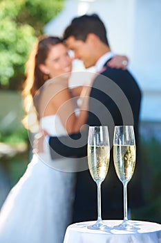 Drinks, champagne and happy couple in embrace at wedding with love, smile and commitment at reception. Wine glass, woman