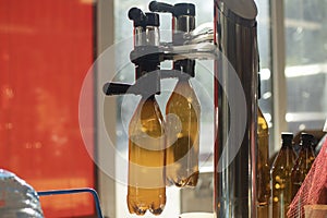 Drinks on tap. Alcol machine for filling in plastic bottles. Beer is poured into bottle