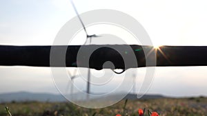 A drip irrigation system dribble in wind turbine background. The concept of renewable energy, clean energy, and efficiency.