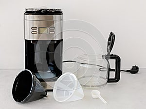 Drip-type coffee maker comprises: coffee machine, glass jug, removable filter holder, basket mesh filter and measuring spoon. photo