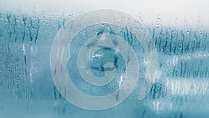 Dripping Condensation on the clear glass window. Water drops. Abstract background texture. Detail of moisture close up