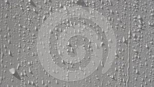 Dripping drops of water or rain on a clean white surface. Moisture condensation on a white background