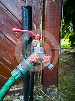 Dripping harden water tap with hose
