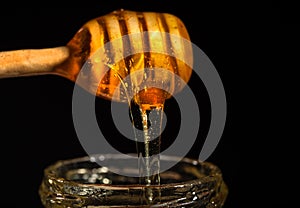 Honey dripping isolated on black background