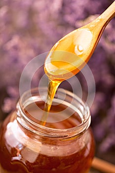 Dripping honey from wooden spoon