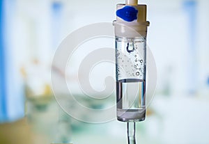 Dripping medical perfusion close up equipment in clinic background. Saline Solution IV Drip Fluid for Infusion in Hospital. Intrav