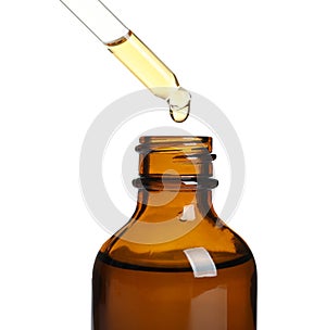 Dripping natural tea tree essential oil into bottle