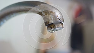 Dripping old, rusty kitchen faucet. water dripping from a tap close up. Lack of clean water, reckless use of resources.