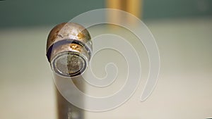 Dripping old, rusty kitchen faucet. water dripping from a tap close up. Lack of clean water, reckless use of resources.