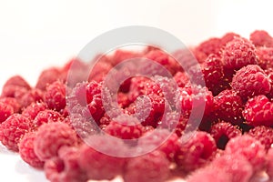 Dripping raspberry on white background.