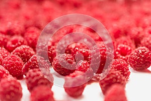 Dripping raspberry on white background.