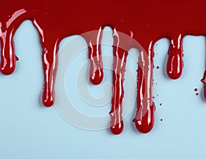 Dripping red liquid on white background