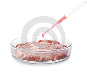 Dripping sample onto piece of raw cultured meat on white background