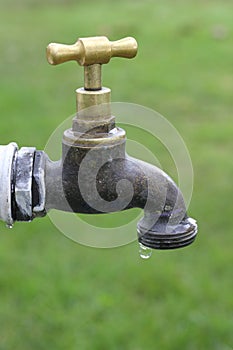 Dripping water faucet in garden