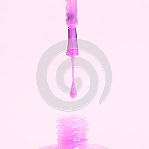 drippy pink colored nail polish isolated white background. High quality photo