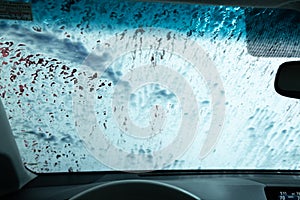 Drive Through Car Wash from Inside an Automobile Being Washed
