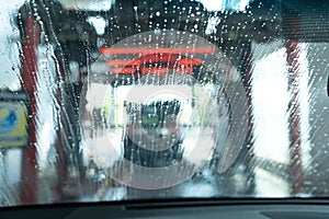 Drive Through Car Wash from Inside an Automobile Being Washed