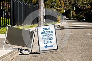 Drive through COVID-19 testing clinic sign on a road