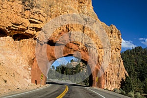 Drive-through red stone arch over highway in Red Rock Canyon Utah