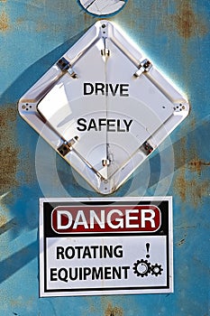 A Drive Safely and Danger Rotating Equipement sign