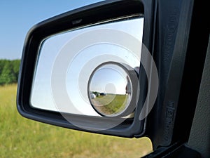 Drive side rear view mirror with additional round safety mirror