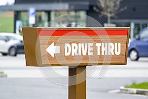Drive Thru sign near a fast food restaurant showind the direction for cars