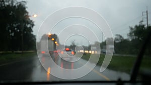 Drive on the way in the rain with blurred background and light bokeh on the evening